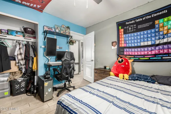 a bedroom with a bed gym equipment and view of living room