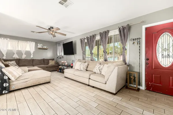 a living room with furniture and a large window