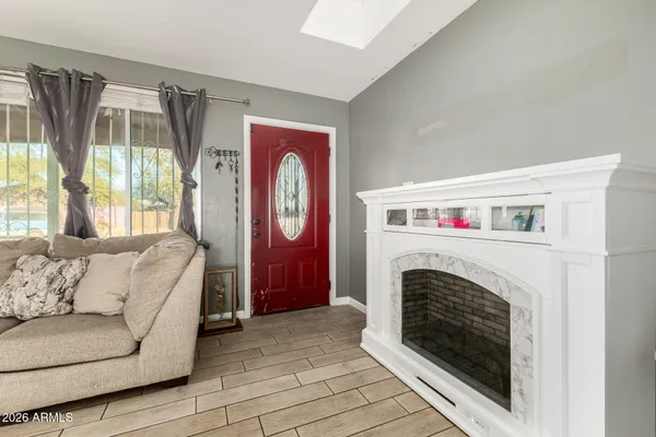 a living room with furniture and a fireplace