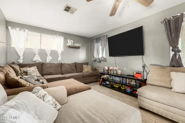 a living room with furniture and a flat screen tv