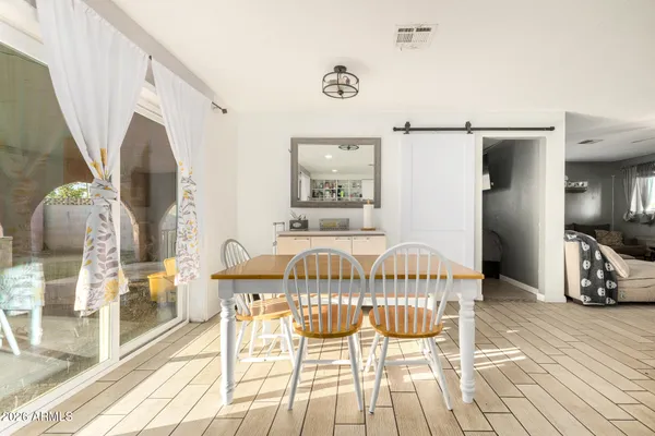 a view of a dining room with furniture and wooden floor
