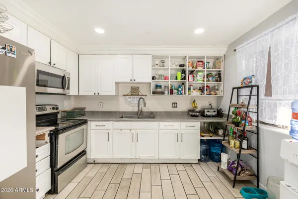 a kitchen with stainless steel appliances granite countertop a stove and a sink