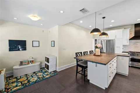 a kitchen with stainless steel appliances granite countertop a stove a sink and a refrigerator