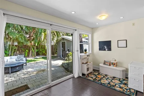 a room with a baby bed furniture and a large window