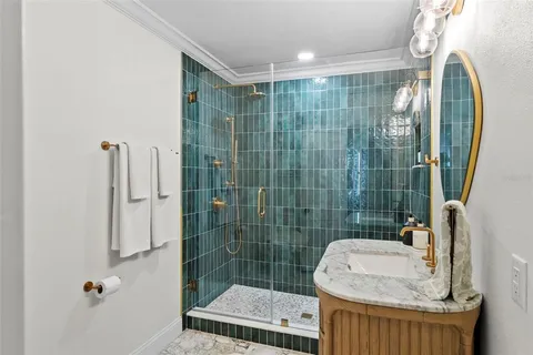 a bathroom with a shower a sink and mirror