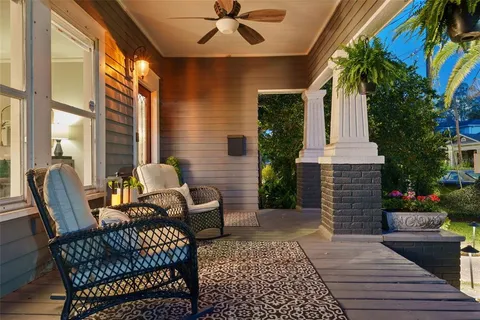 a view of a porch with furniture and a fireplace