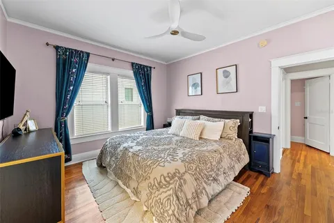 a bed sitting in a bedroom next to a window