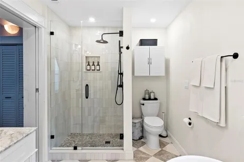 a bathroom with a shower toilet and sink