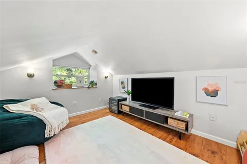 a bedroom with a bed and a flat screen tv