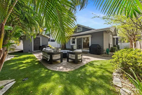 a view of a house with backyard and sitting area