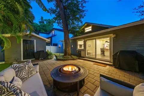 a view of a house with backyard and sitting area