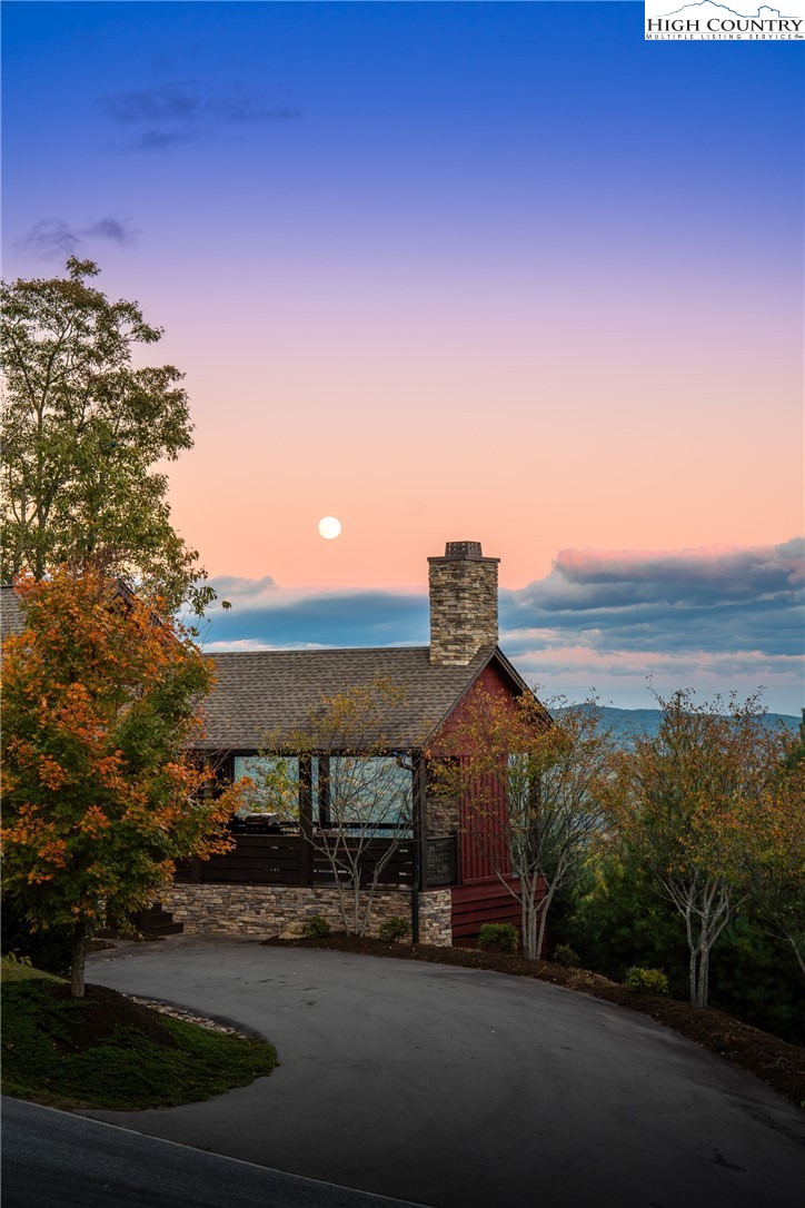 1253 Goldenrod Road Boone, NC 28607 - Photo 26 of 48 a front view of a house with a yard and mountain view in back