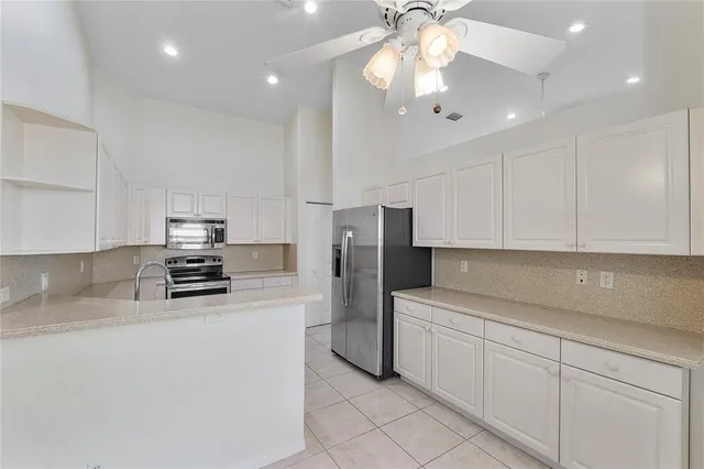 a kitchen with stainless steel appliances a refrigerator sink and microwave