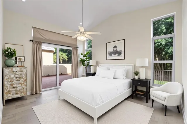 a bedroom with a large bed and a chandelier