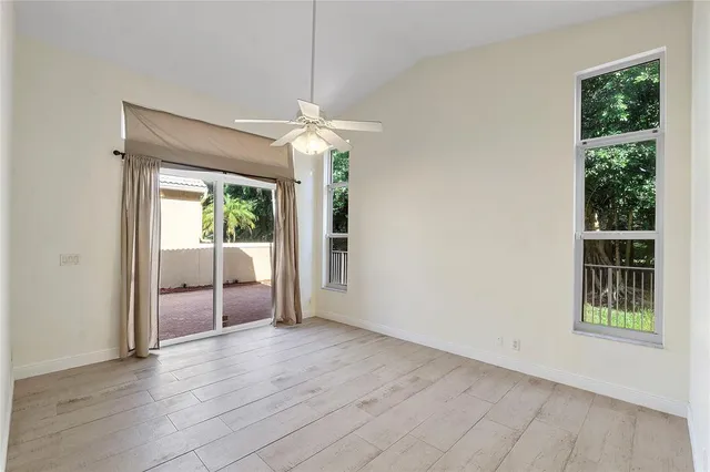 a view of a livingroom with a ceiling fan window and hardwood floor