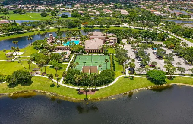 an aerial view of a house with a yard lake garage and lake view