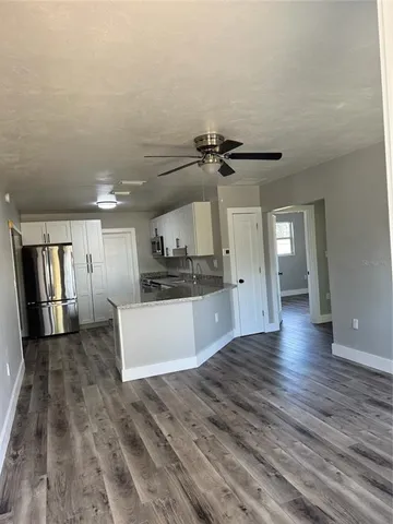 a view of a kitchen with a sink cabinets and wooden floor