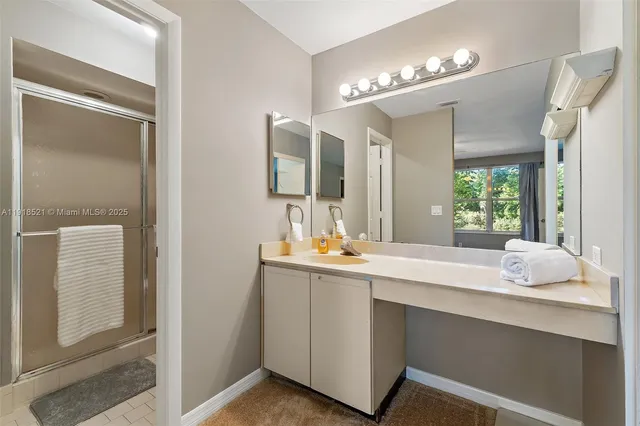a bathroom with a sink vanity and mirror
