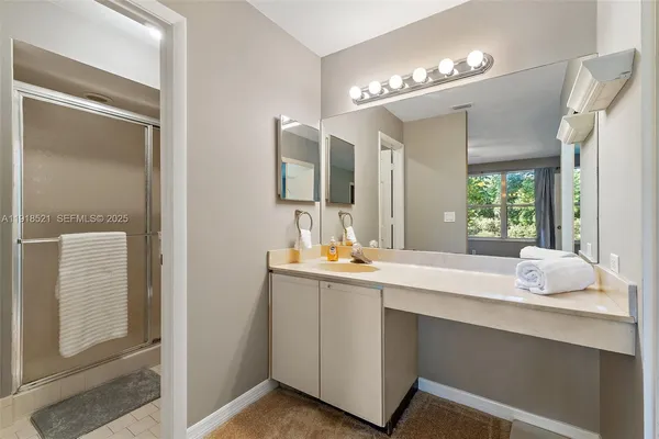 a bathroom with a sink vanity and mirror