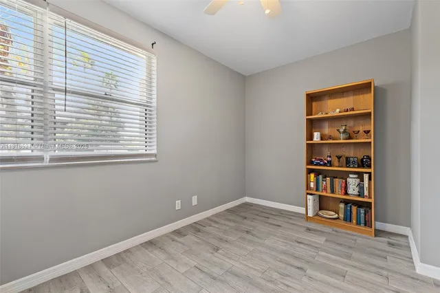 a room with a book shelf and a window