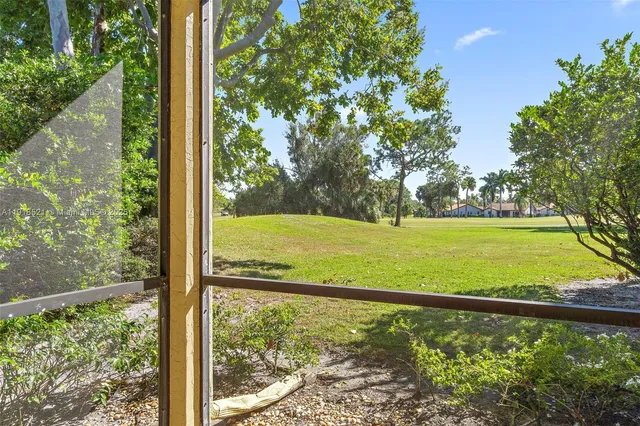 a view of a room with large trees