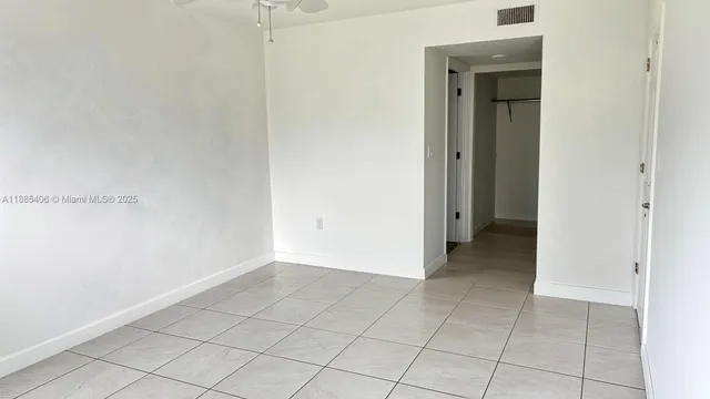 a view of an empty room and closet area