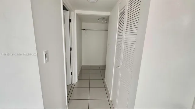 a bathroom with a shower and a glass door