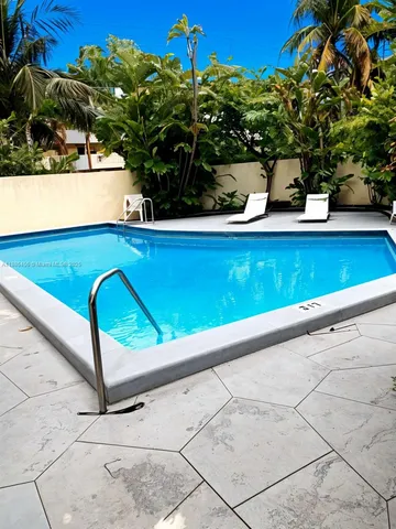 a view of a dining room with furniture and windows
