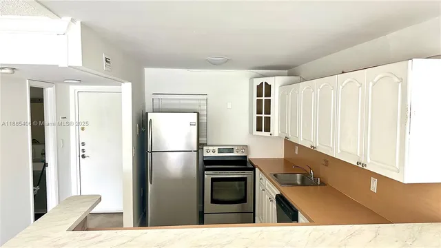 a kitchen with a refrigerator and a sink