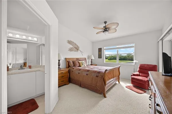 a large bedroom with a bed and glass windows
