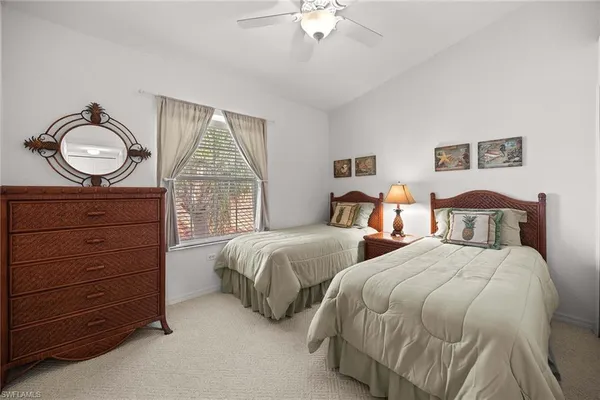 a bedroom with two beds and a large window