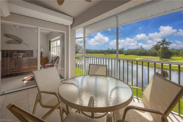 a balcony with table and chairs