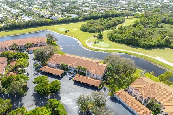 an aerial view of a house with a garden and lake view