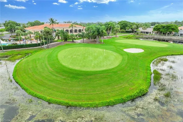 a aerial view of a house with a yard table and chairs