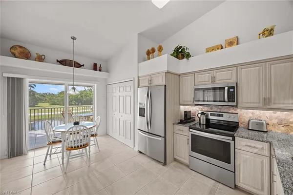a kitchen with stainless steel appliances a stove a sink and a refrigerator