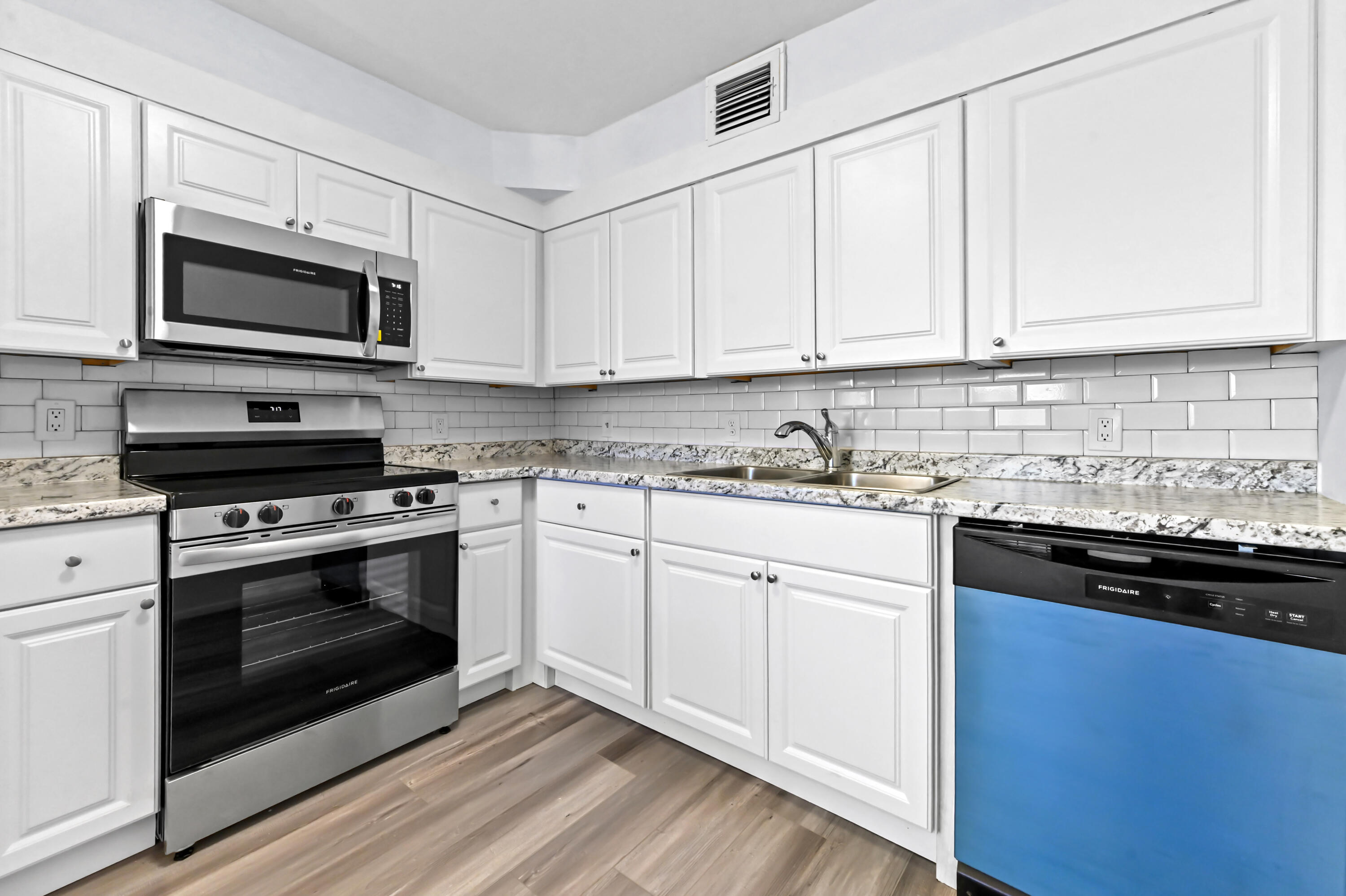 3046 Newcastle A Boca Raton, FL 33434 - Photo 11 of 25 a kitchen with stainless steel appliances granite countertop a stove a microwave and oven