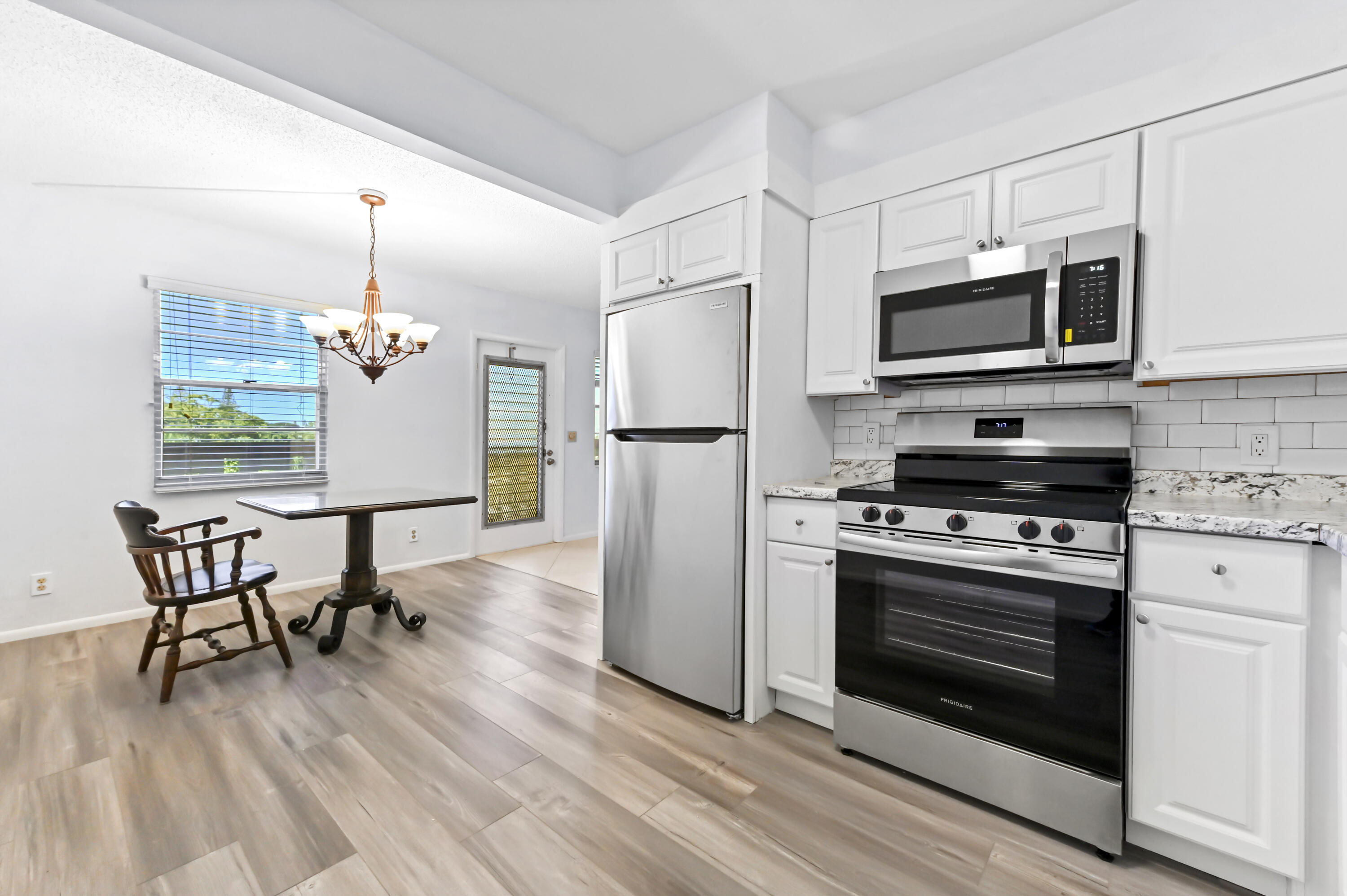 3046 Newcastle A Boca Raton, FL 33434 - Photo 12 of 25 a kitchen with stainless steel appliances a stove a microwave and a refrigerator