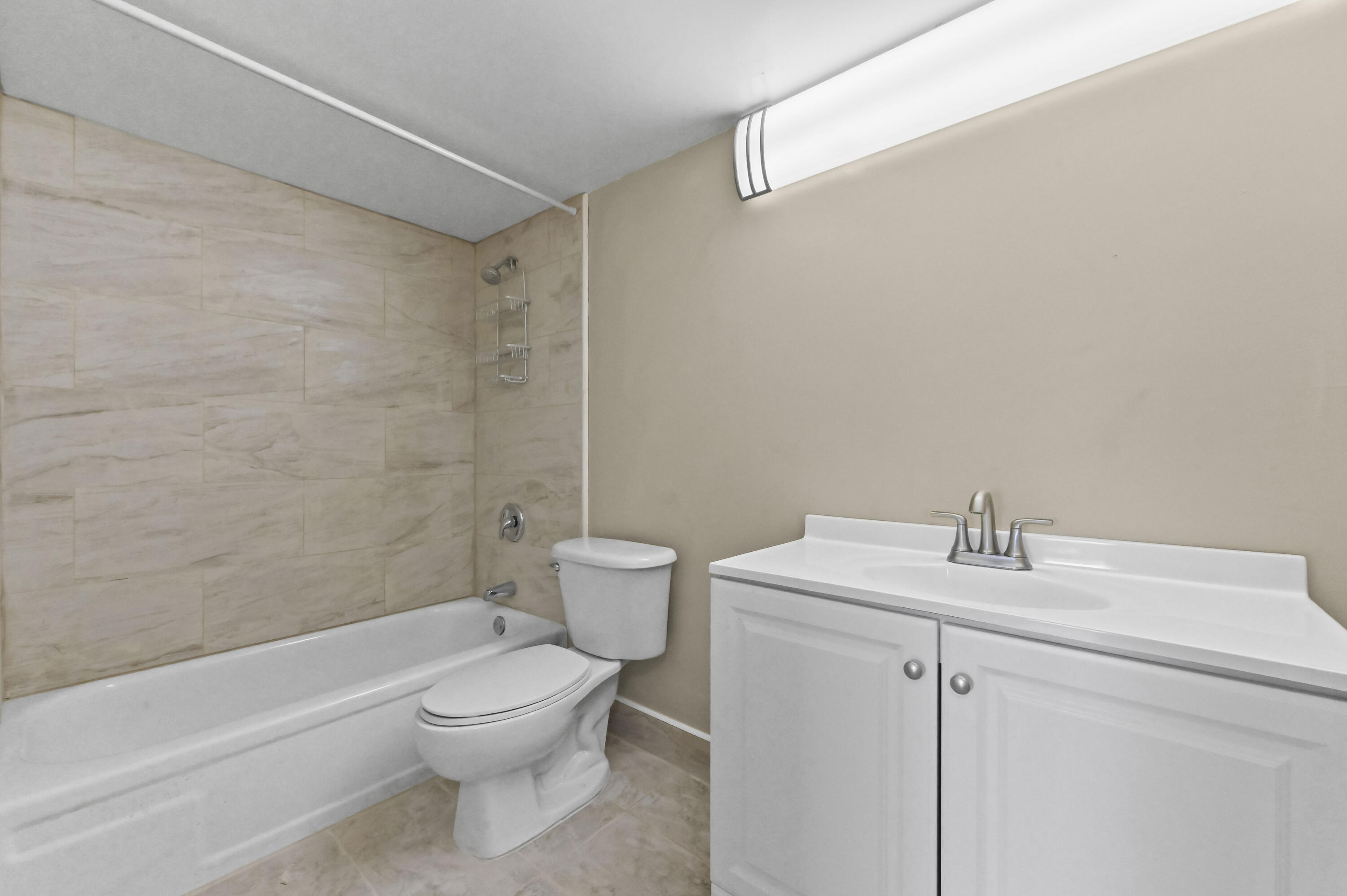 3046 Newcastle A Boca Raton, FL 33434 - Photo 15 of 25 a bathroom with a sink a toilet and shower
