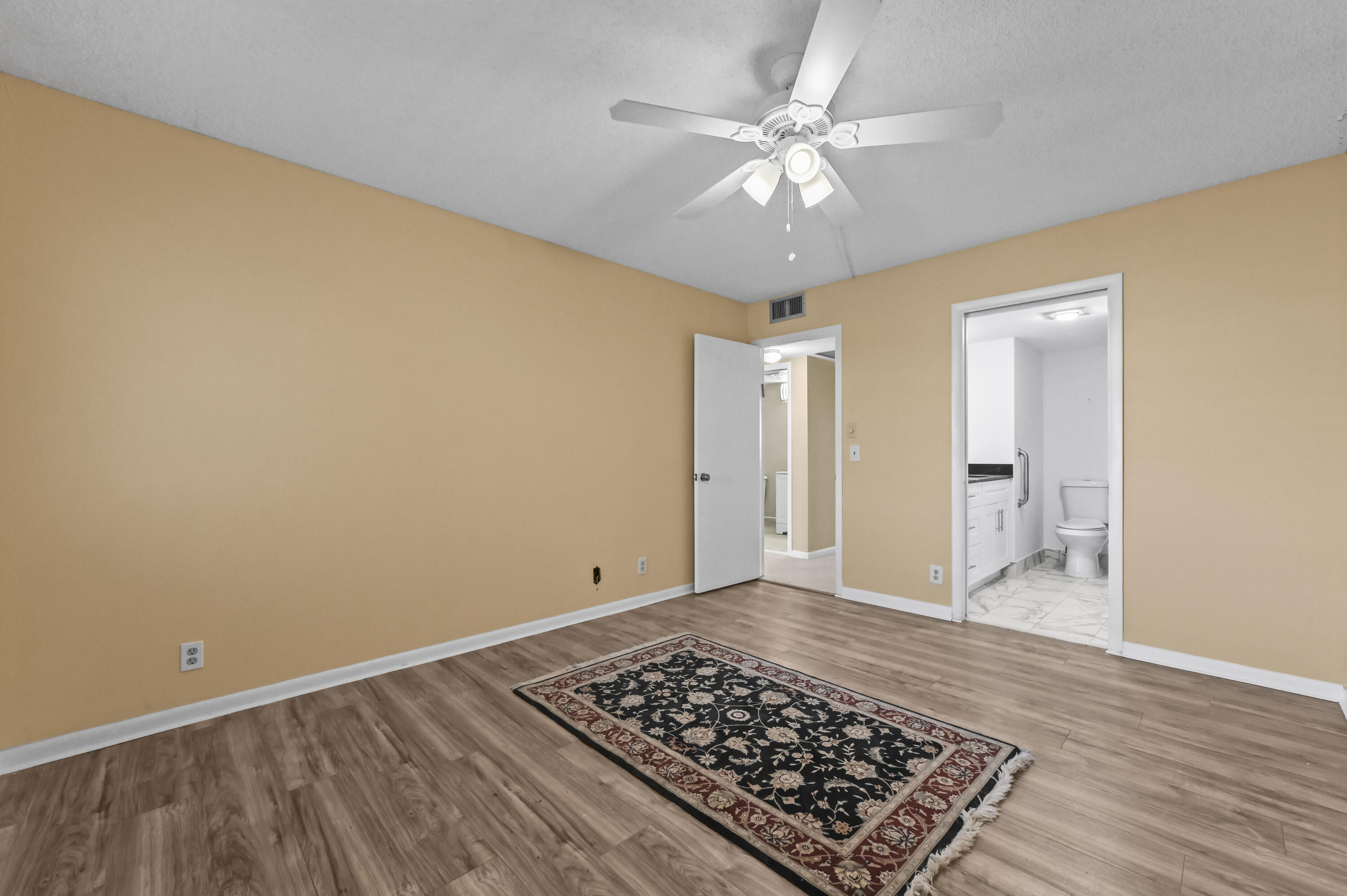 3046 Newcastle A Boca Raton, FL 33434 - Photo 18 of 25 a view of a room with wooden floor and white walls