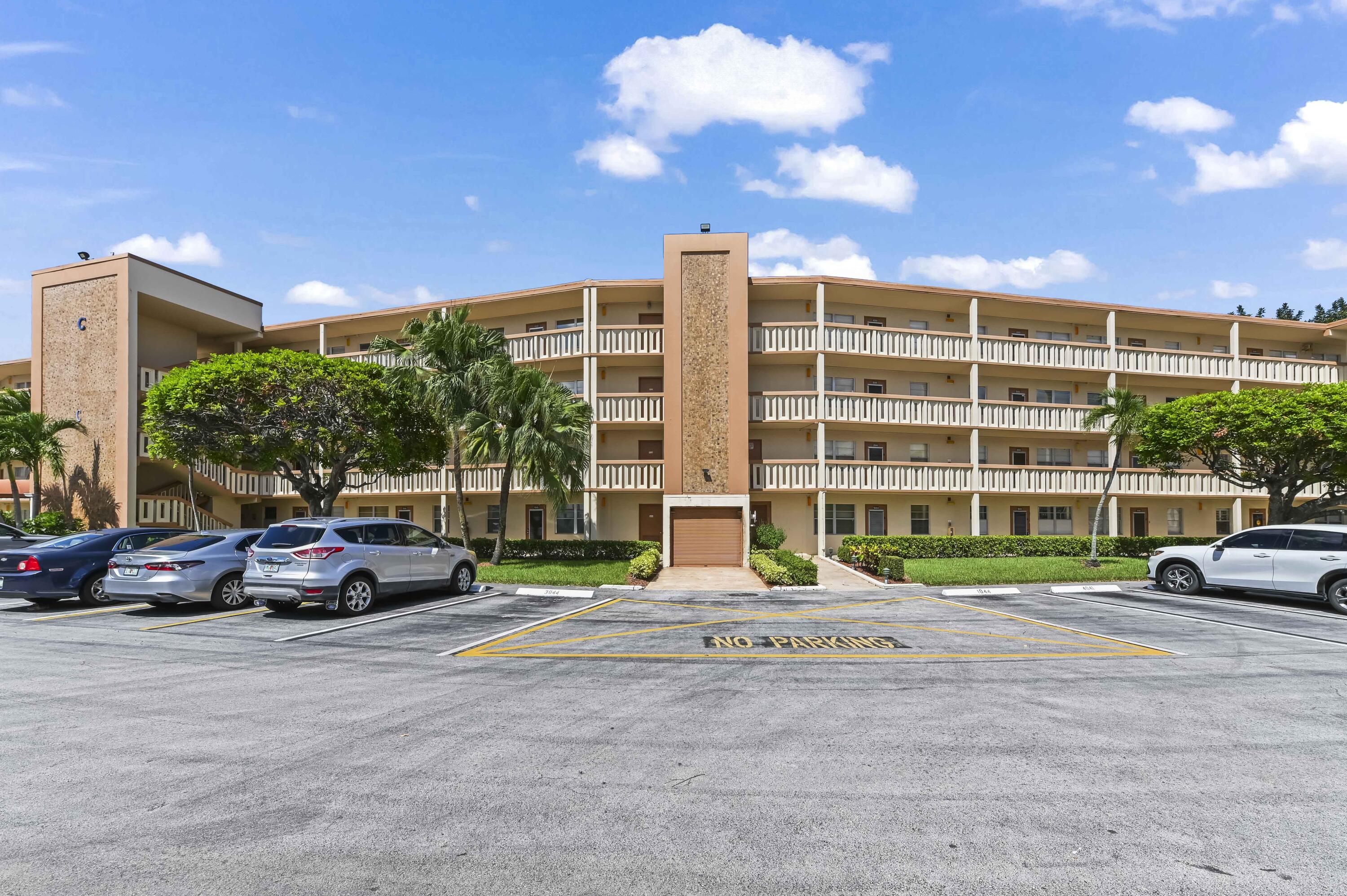 3046 Newcastle A Boca Raton, FL 33434 - Photo 2 of 25 a cars parked in front of a building