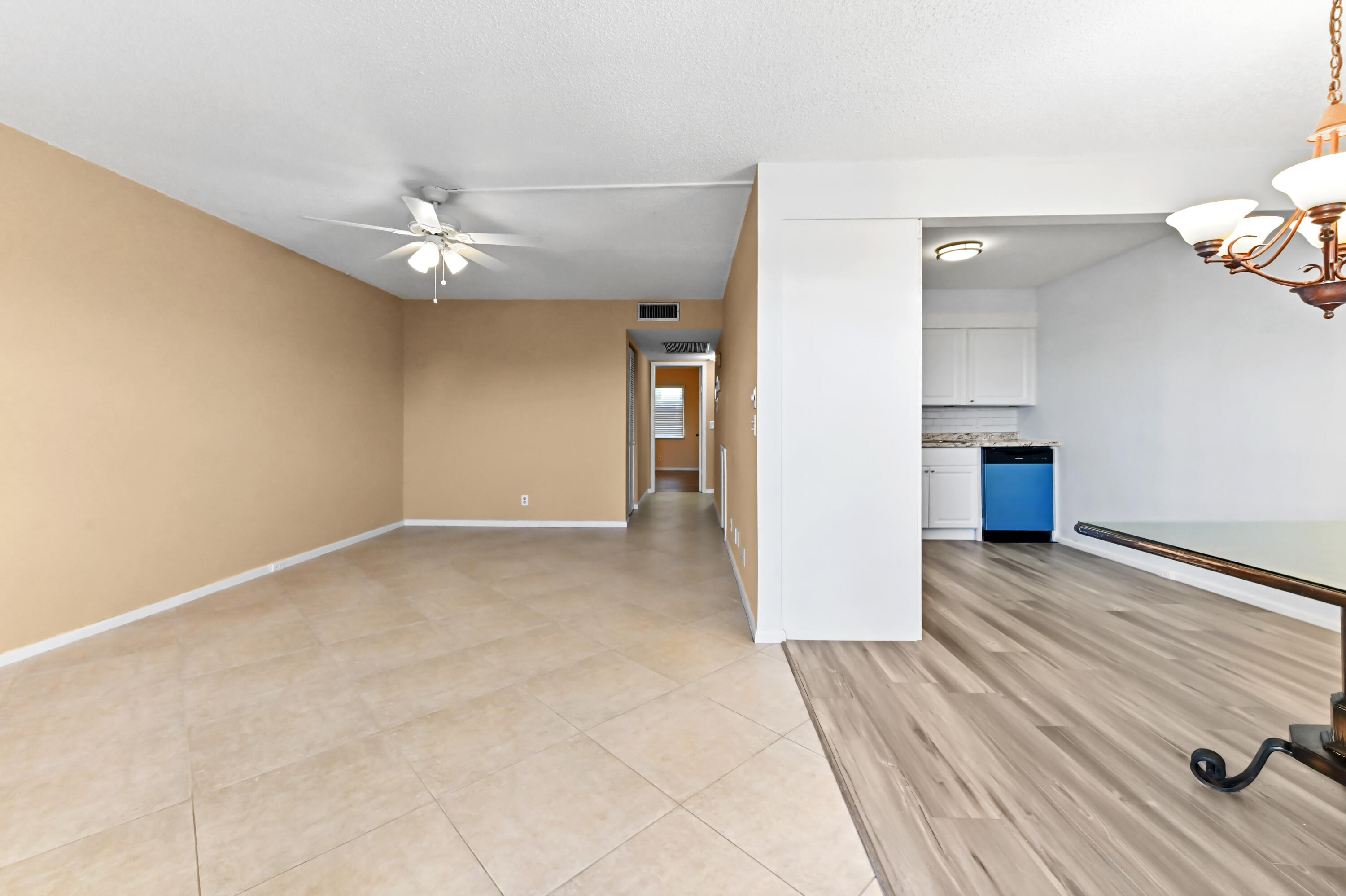 3046 Newcastle A Boca Raton, FL 33434 - Photo 4 of 25 wooden floor in an empty room with a window