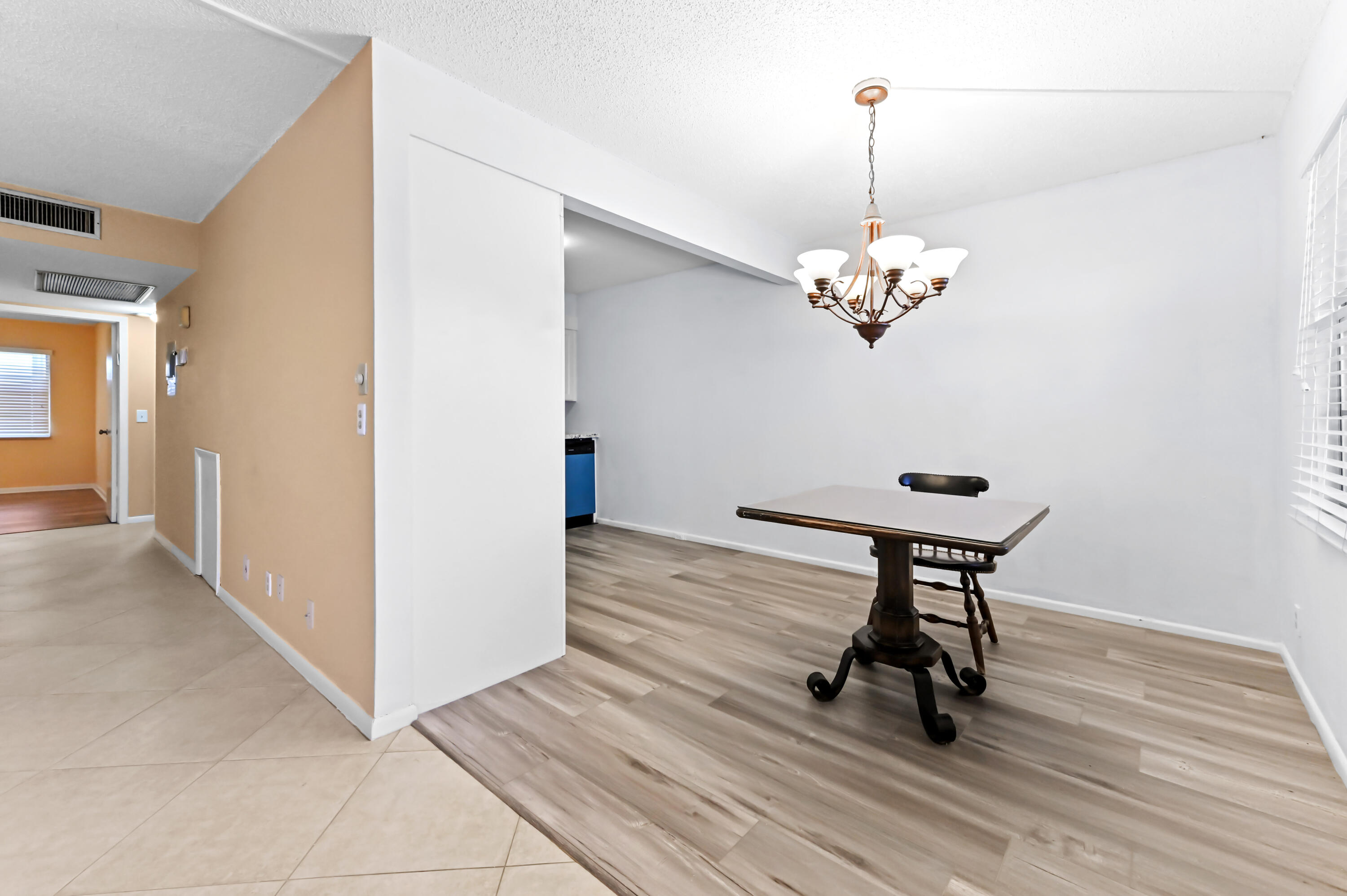 3046 Newcastle A Boca Raton, FL 33434 - Photo 8 of 25 a view of a room with wooden floor and chairs
