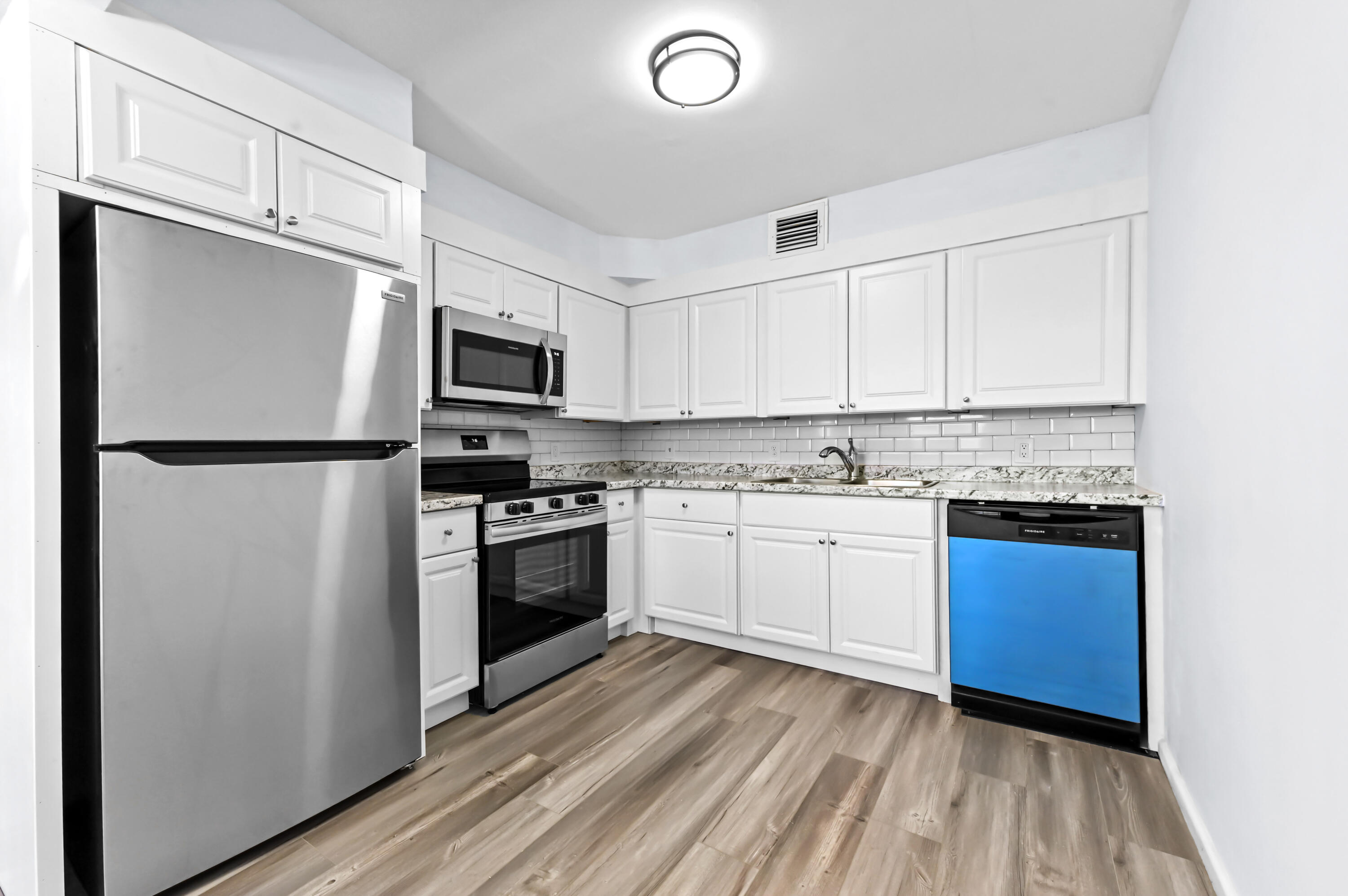 3046 Newcastle A Boca Raton, FL 33434 - Photo 10 of 25 a kitchen with a refrigerator stove and microwave