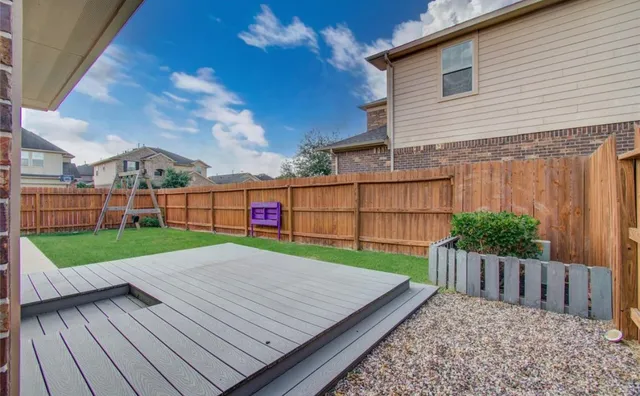 a view of a backyard with wooden floor