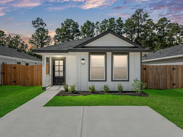 a front view of a house with a yard and a garage