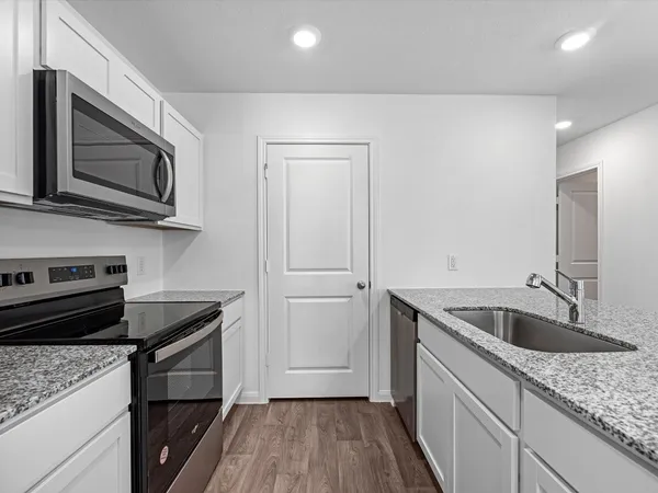 a kitchen with a sink dishwasher microwave and stove