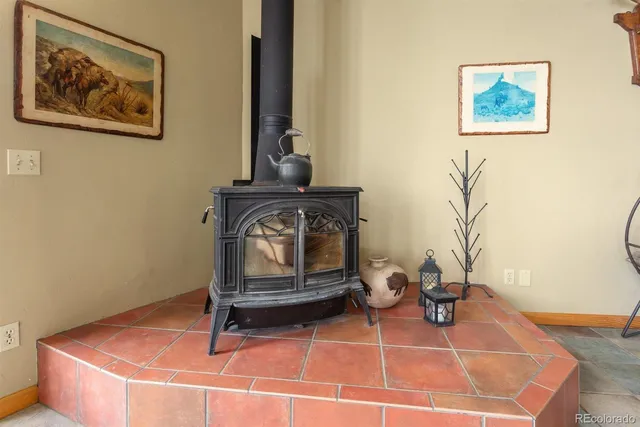 a kitchen with stainless steel appliances granite countertop a stove top oven a sink and white cabinets with wooden floor