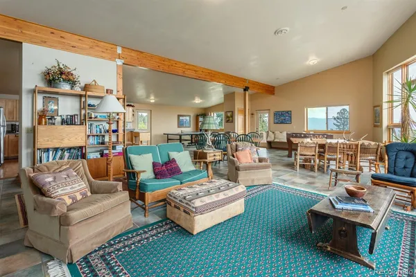 a kitchen with granite countertop a refrigerator a stove and white cabinets with wooden floor