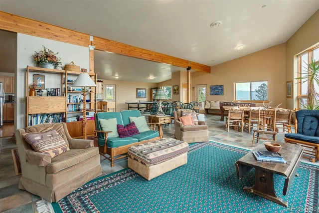 a kitchen with granite countertop a refrigerator a stove and white cabinets with wooden floor