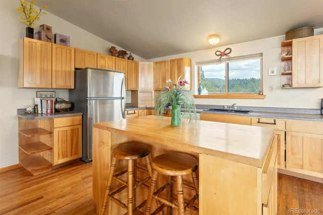 a view of a kitchen with kitchen island a large window